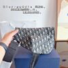 692f11be4ecd253cf1078dbd Dior Saddle Bag Homme - A Bold Statement in Streetwear Elegance