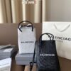 692fabcf99f2d84055c86513 Balenciaga Mini Tote Bag Limited Edition at Boutique, Featured by Entertainment Weekly - Stylish Black and White Design