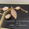 692fc16499f2d84055c88352 Lucky Spring Collection featuring ladybug and floral motifs, celebrating the rebirth of nature cherished by Van Cleef & Arpels. Crafted in rose gold, carnelian, and onyx, this collection enriches the Maison's enchanting connection with the natural world. Five meticulously handcrafted elements are delicately assembled into each piece. The chain is a specially customized thick design by Van Cleef & Arpels, with each link featuring eight faceted surfaces for enhanced sparkle. The tassel leaves are crafted with a crinkled foil texture for a refined, luxurious effect. The 'LG' engraving is discreetly placed on the side of the flower, while three totem stamps are embossed on the extension chain, and a serial code is engraved above the lobster clasp.