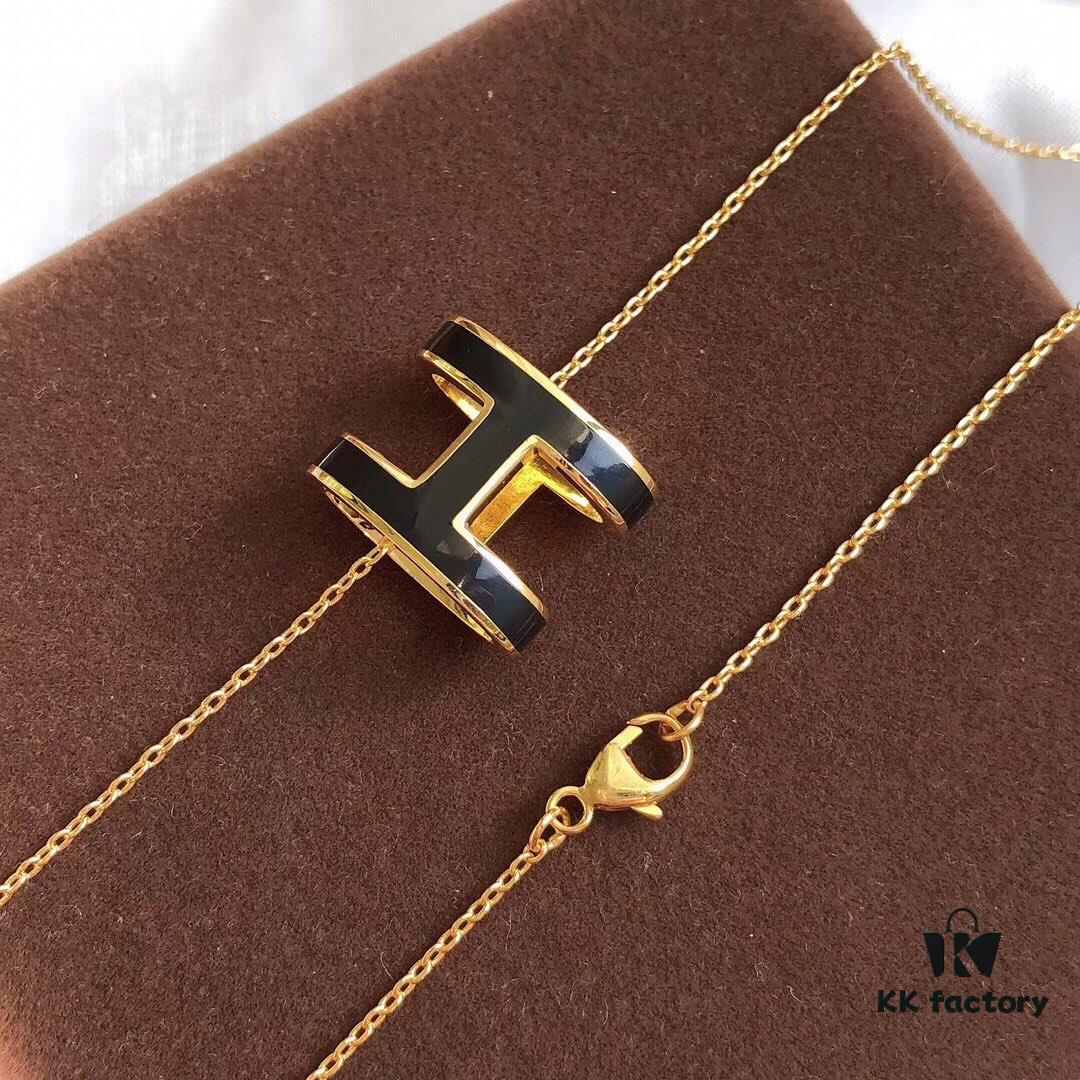 692fc84b99f2d84055c88ef5 Hermès Enamel Curved H Necklace in Gold Tones