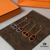 692fcbc699f2d84055c8950b Hermes Chaine d'Ancre Verso Asymmetric Pig Nose Earrings in Yellow Gold, Rose Gold, and Black Ceramic