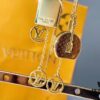 692fcc9d99f2d84055c896b1 Louis Vuitton Boite Chapeau Bag in Monogram Canvas and Gold-Tone Metal, Adorning Mini LV Asymmetrical Earrings