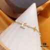 692fcced99f2d84055c89756 LV Gold-Tone Letter and Flower Bracelet