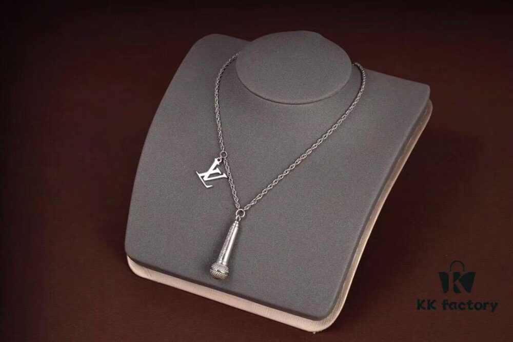 692fcd8199f2d84055c89869 LV Microphone Necklace 🎤 Featuring the DJ-inspired design by former Men's Artistic Director Virgil Abloh, this pendant captures the essence of music culture with a finely etched microphone charm and delicately suspended LV initials on a sleek chain. Metal hardware, microphone-shaped pendant, LV letter detailing—perfect for gifting or personal wear!