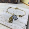 692fd11499f2d84055c89edc A pair of name tags engraved with the classic LV Initials signature, featuring contrasting gold and silver finishes, a soft pearl chain, and a buckle adorned with the LV Circle logo.