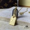 692fd11499f2d84055c89edd A pair of name tags engraved with the classic LV Initials signature, featuring contrasting gold and silver finishes, a soft pearl chain, and a buckle adorned with the LV Circle logo.