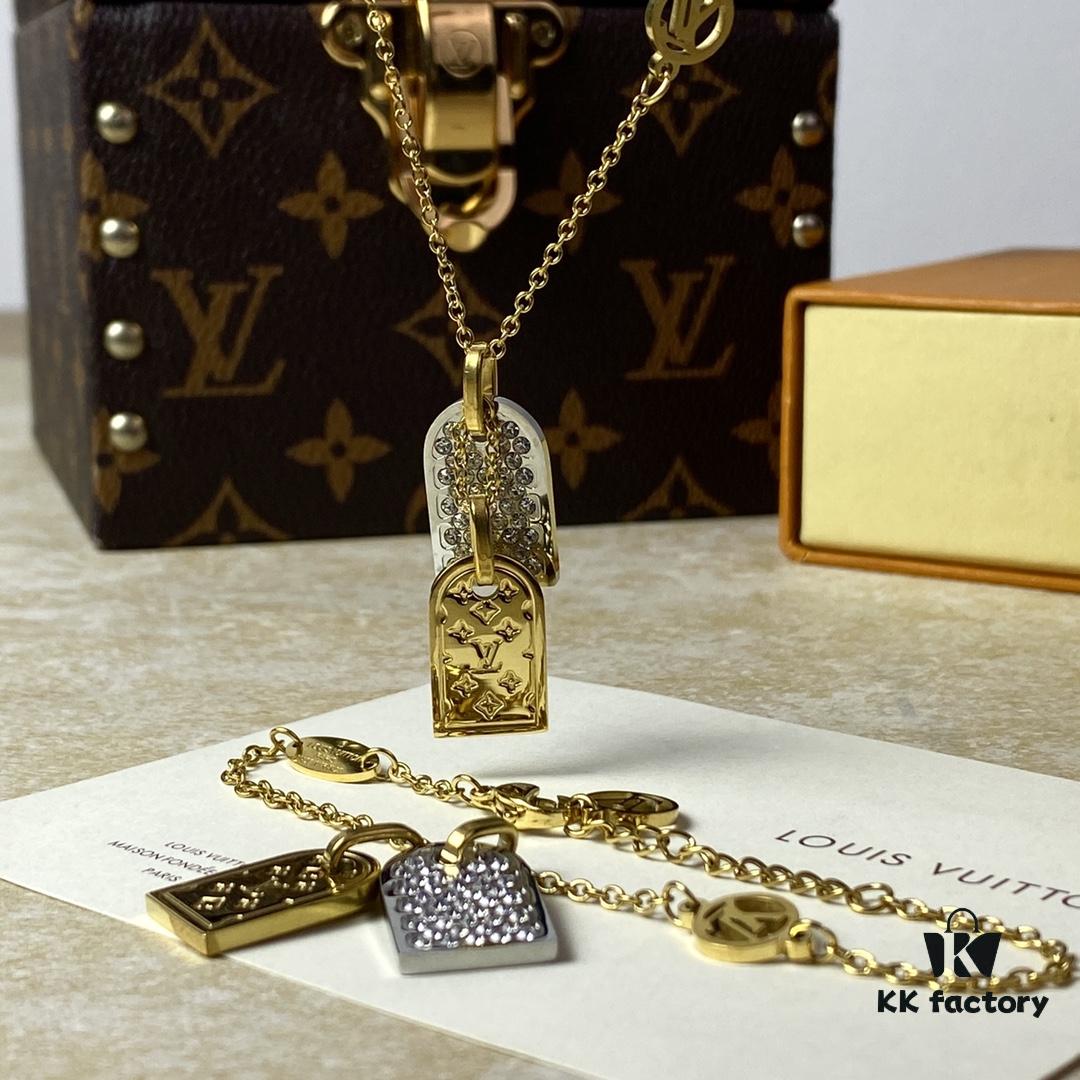 692fd11899f2d84055c89ee0 A pair of name tags engraved with the classic LV Initials signature, featuring contrasting gold and silver finishes, a soft pearl chain, and a buckle adorned with the LV Circle logo.