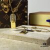 692fd11899f2d84055c89ee1 A pair of name tags engraved with the classic LV Initials signature, featuring contrasting gold and silver finishes, a soft pearl chain, and a buckle adorned with the LV Circle logo.