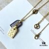 692fd11899f2d84055c89ee5 A pair of name tags engraved with the classic LV Initials signature, featuring contrasting gold and silver finishes, a soft pearl chain, and a buckle adorned with the LV Circle logo.