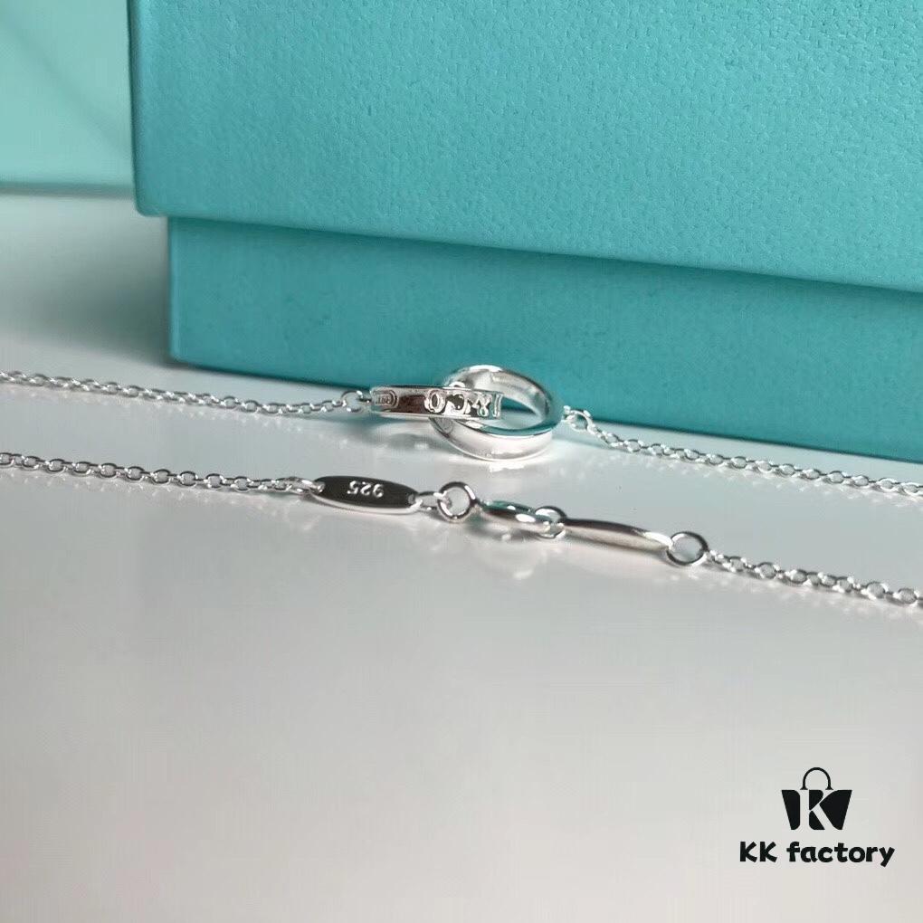 692fd58099f2d84055c8a702 Tiffany & Co. T1837 Double Ring Necklace with Toggle Closure, Fashionable Silver Pendant Inspired by the Brand's Founding Year