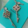 692fd61f99f2d84055c8a860 Tiffany & Co. Classic Double Key Snowflake Sweater Chain with Small Yellow Diamond Accents, Featuring Elegant Logo, Available in White Gold and Rose Gold