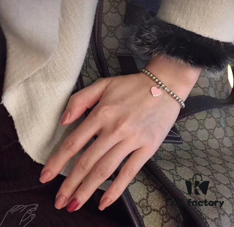Woman Wearing Tiffany Heart Bracelet