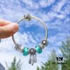692fe61099f2d84055c8c388 Pandora Night Glow Mint Dreamcatcher New Arrival! Crafted with genuine counter materials, perfectly replicating the original design, quality comparable to official retail. Features night-glow mint glass beads, fully diamond-encrusted daisy flower beads, lucky coin beads, enamel daisy spacer beads, accented with a meaningful dreamcatcher pendant. Made in S925 silver and comes with official retail packaging!