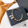 692fe9c199f2d84055c8c9fa APM Monaco Lucky Little Fish Bracelet with Sliding Ring in Gold-Tone, Stylish and Unique Open Cuff Bangle Jewelry in Silver
