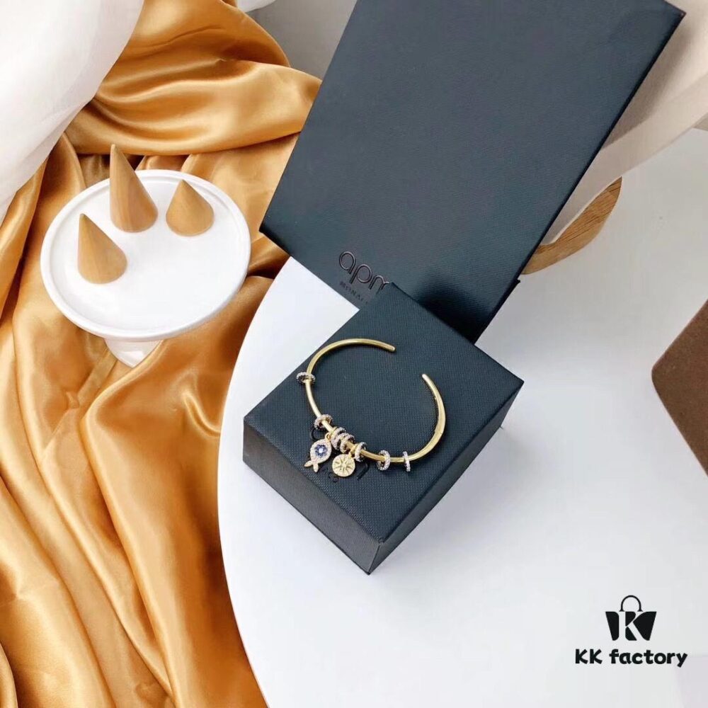 692fe9da99f2d84055c8ca1d APM Monaco Lucky Little Fish Bracelet with Sliding Ring in Gold-Tone, Stylish and Unique Open Cuff Bangle Jewelry in Silver