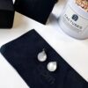 692fea2899f2d84055c8ca9a APM Monaco Silver Crystal-Encrusted Mother-of-Pearl Earrings for Women, Delicate Petal Design, Elegant White Mother-of-Pearl Studs That Make You Radiant from Every Angle