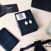 692fea2a99f2d84055c8ca9e APM Monaco Silver Crystal-Encrusted Mother-of-Pearl Earrings for Women, Delicate Petal Design, Elegant White Mother-of-Pearl Studs That Make You Radiant from Every Angle