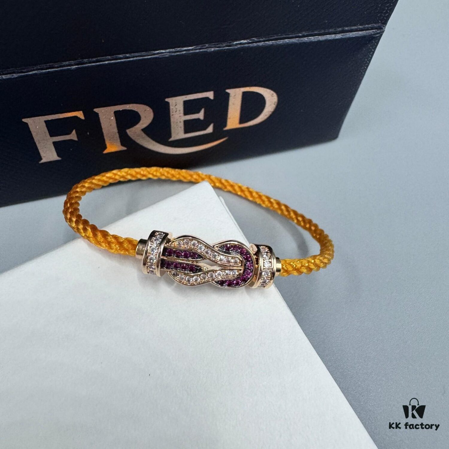 692ff69e99f2d84055c8dfb2 FRED Force 10 Bracelet in Rose Gold, Medium Size with Ruby Cabochon and Stainless Steel Cord