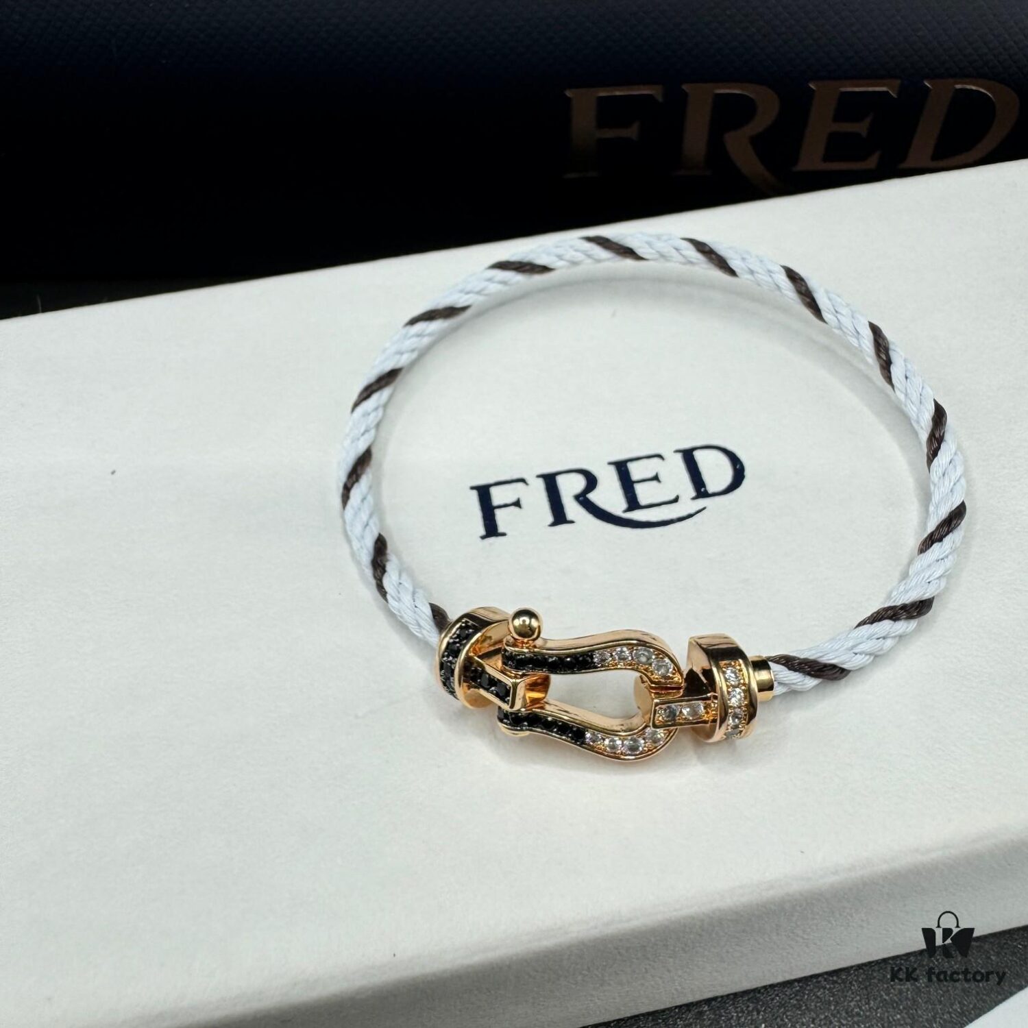 692ff6aa99f2d84055c8dfc1 FRED Force 10 Bracelet in Rose Gold, Medium Size with Black and White Gemstones, Steel Cord Design