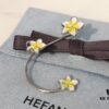 693004ea12f62673a6fab0bc HEFANG Jewelry Frangipani Huggie Earrings