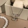 69300a9a12f62673a6faba34 Chrome Hearts Cat's Eye Bracelet & Vivienne Westwood Bow Galaxy Bracelet