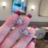69300d9c12f62673a6fabfca Vivian New Saturn Stud Earrings