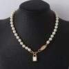 69300da012f62673a6fabfd2 Wholesale European and American Fashion Jewelry Saturn Pearl and Enamel 3D Small Lock Necklace for Women, Drop Shipping Available