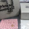 6930107d12f62673a6fac42e Vivienne Westwood Black Gun Color Saturn Pearl Necklace