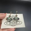 693010f112f62673a6fac4bd Vivienne Westwood Transparent Glass Orb Earrings in White Gold, Yellow Gold, and Rose Gold