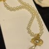 6930119c12f62673a6fac596 Vivienne Westwood Golden Saturn ORB Pearl Necklace