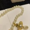 6930119f12f62673a6fac598 Vivienne Westwood Golden Saturn ORB Pearl Necklace