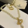 693011a112f62673a6fac59a Vivienne Westwood Golden Saturn ORB Pearl Necklace