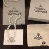 693011b812f62673a6fac5c1 Vivienne Westwood Saturn Pearl Necklace - Medium Size, Rhinestone-Embellished Crown Pendant with Elegant Shine