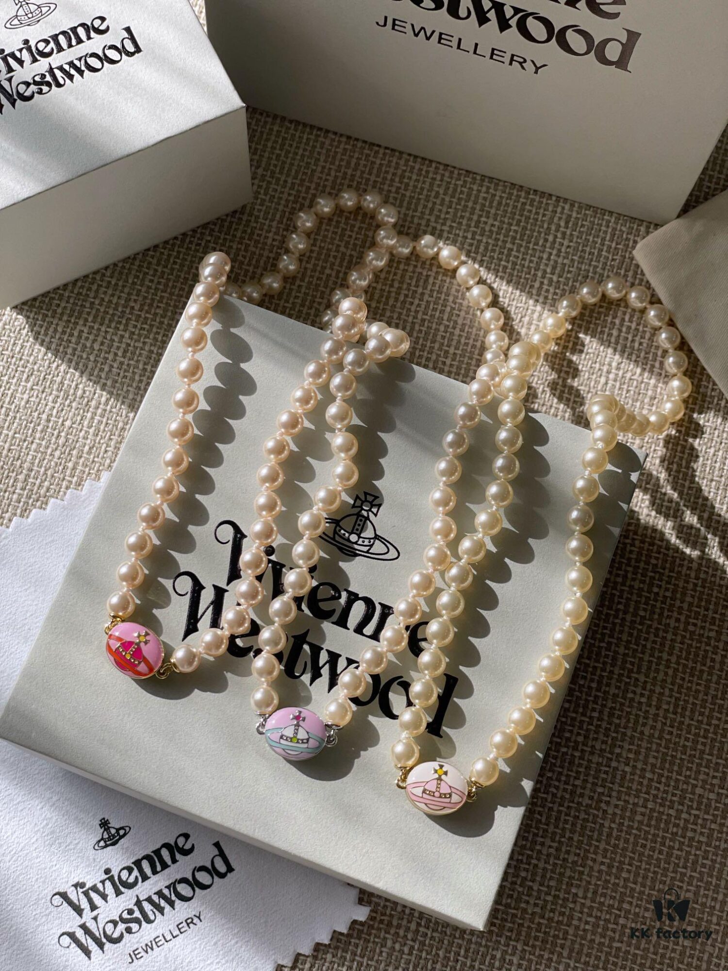 693011c612f62673a6fac5d5 Vivienne Westwood Enamel Pearl Necklace with Magnetic Clasp, Double-Sided Wear, Saturn and Crown Design, Elegant and Edgy Style