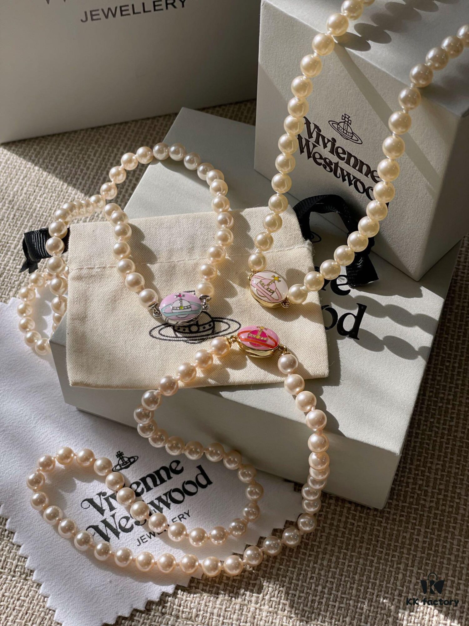 693011c712f62673a6fac5d6 Vivienne Westwood Enamel Pearl Necklace with Magnetic Clasp, Double-Sided Wear, Saturn and Crown Design, Elegant and Edgy Style