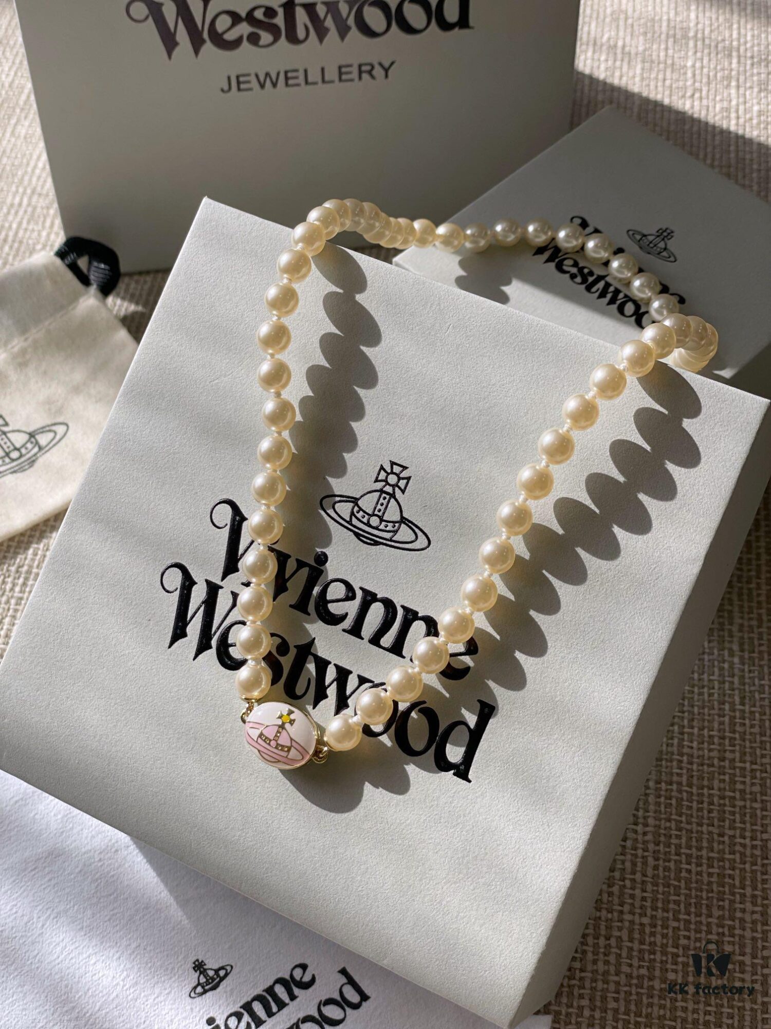 693011c812f62673a6fac5d7 Vivienne Westwood Enamel Pearl Necklace with Magnetic Clasp, Double-Sided Wear, Saturn and Crown Design, Elegant and Edgy Style