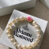 693011c912f62673a6fac5d8 Vivienne Westwood Enamel Pearl Bracelet – Magnetic Clasp, Reversible Design, Six New 2023 Colors Available