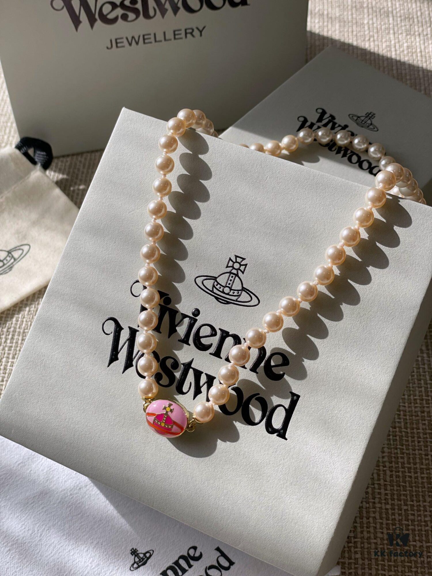 693011cb12f62673a6fac5da Vivienne Westwood Enamel Pearl Necklace with Magnetic Clasp, Double-Sided Wear, Saturn and Crown Design, Elegant and Edgy Style