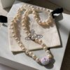 693011cd12f62673a6fac5dd Vivienne Westwood Enamel Pearl Necklace with Magnetic Clasp, Double-Sided Wear, Saturn and Crown Design, Elegant and Edgy Style