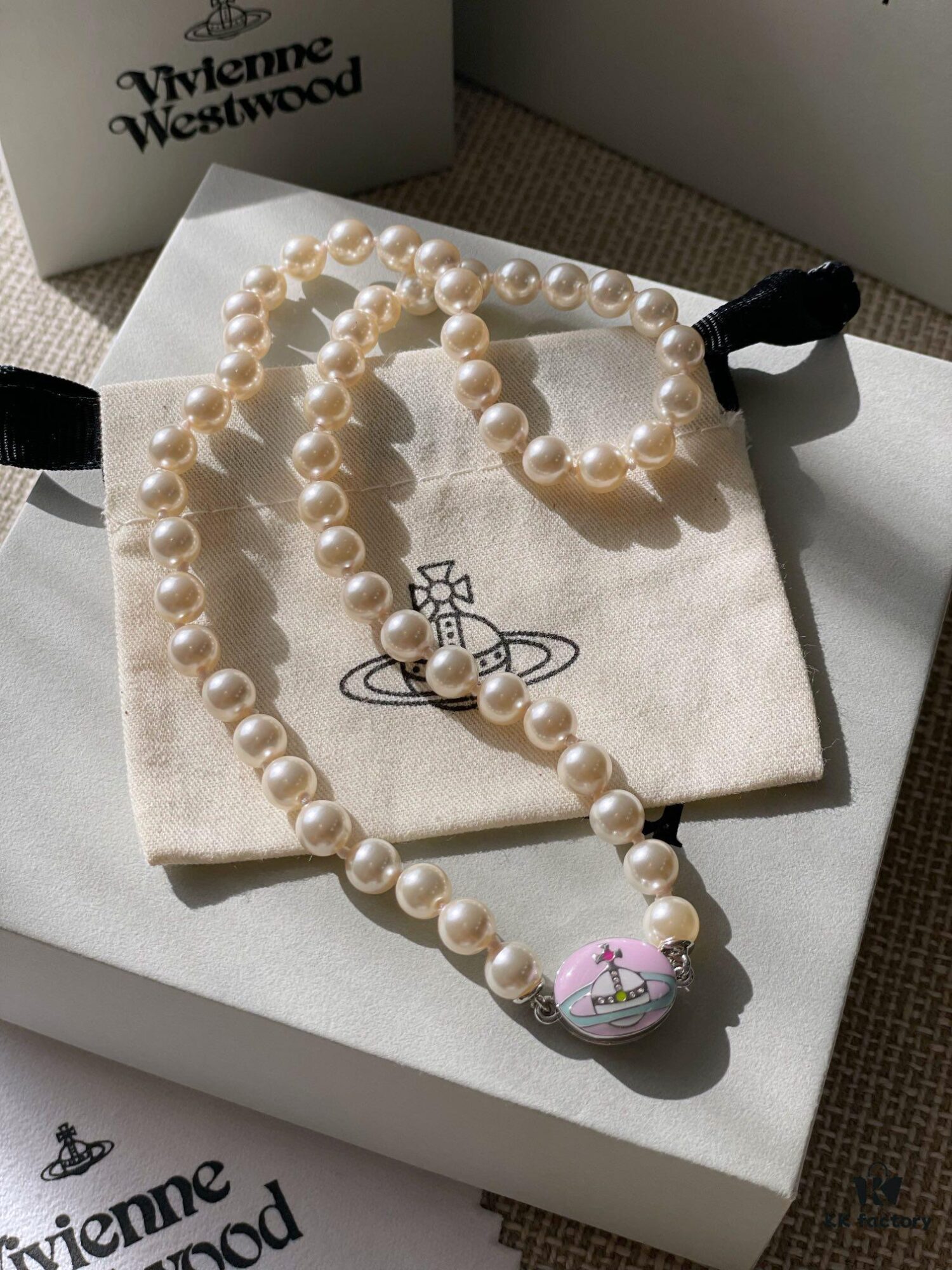 693011cd12f62673a6fac5dd Vivienne Westwood Enamel Pearl Necklace with Magnetic Clasp, Double-Sided Wear, Saturn and Crown Design, Elegant and Edgy Style
