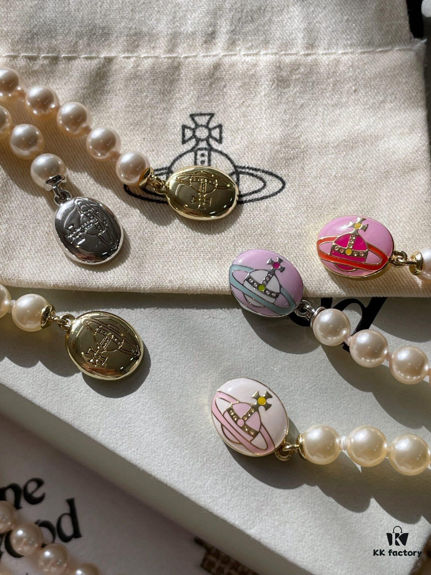 693011ce12f62673a6fac5de Vivienne Westwood Enamel Pearl Necklace with Magnetic Clasp, Double-Sided Wear, Saturn and Crown Design, Elegant and Edgy Style