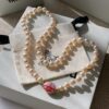 693011db12f62673a6fac5ea Vivienne Westwood Enamel Pearl Necklace with Magnetic Clasp, Double-Sided Wear, Saturn and Crown Design, Elegant and Edgy Style