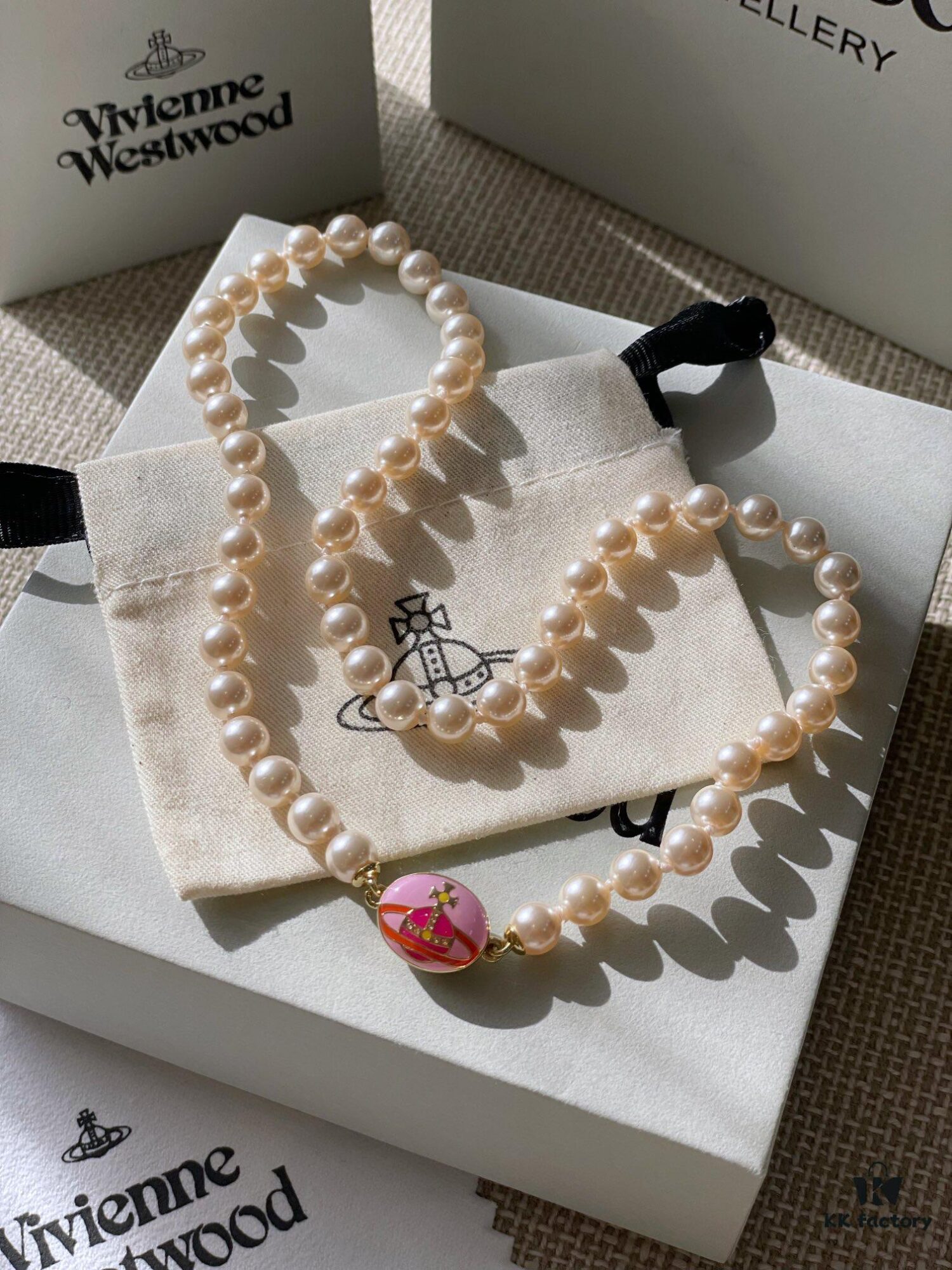 693011db12f62673a6fac5ea Vivienne Westwood Enamel Pearl Necklace with Magnetic Clasp, Double-Sided Wear, Saturn and Crown Design, Elegant and Edgy Style
