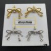 6930179812f62673a6facd58 Miu Miu Textured Luxury Pearl Heart Stud Earrings, Minimalist Design with Retro Charm