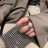 6930181c12f62673a6face38 Platinum-colored Piaget ring with rotating design, featuring single diamond, seven-diamond, and full-diamond options