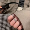 6930183012f62673a6face58 Platinum-colored Piaget ring with rotating design, featuring single diamond, seven-diamond, and full-diamond options