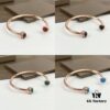 693018d412f62673a6facf56 Piaget Possession Bracelet in Rose Gold with Rotating Circle Set with Two Cabochon Stones and Pavé Diamonds