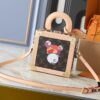 69301ff712f62673a6fad6f0 Top-Quality Replica Dynamic Chip Dual-Color Leather Mini Square Trunk M13127 M14040
