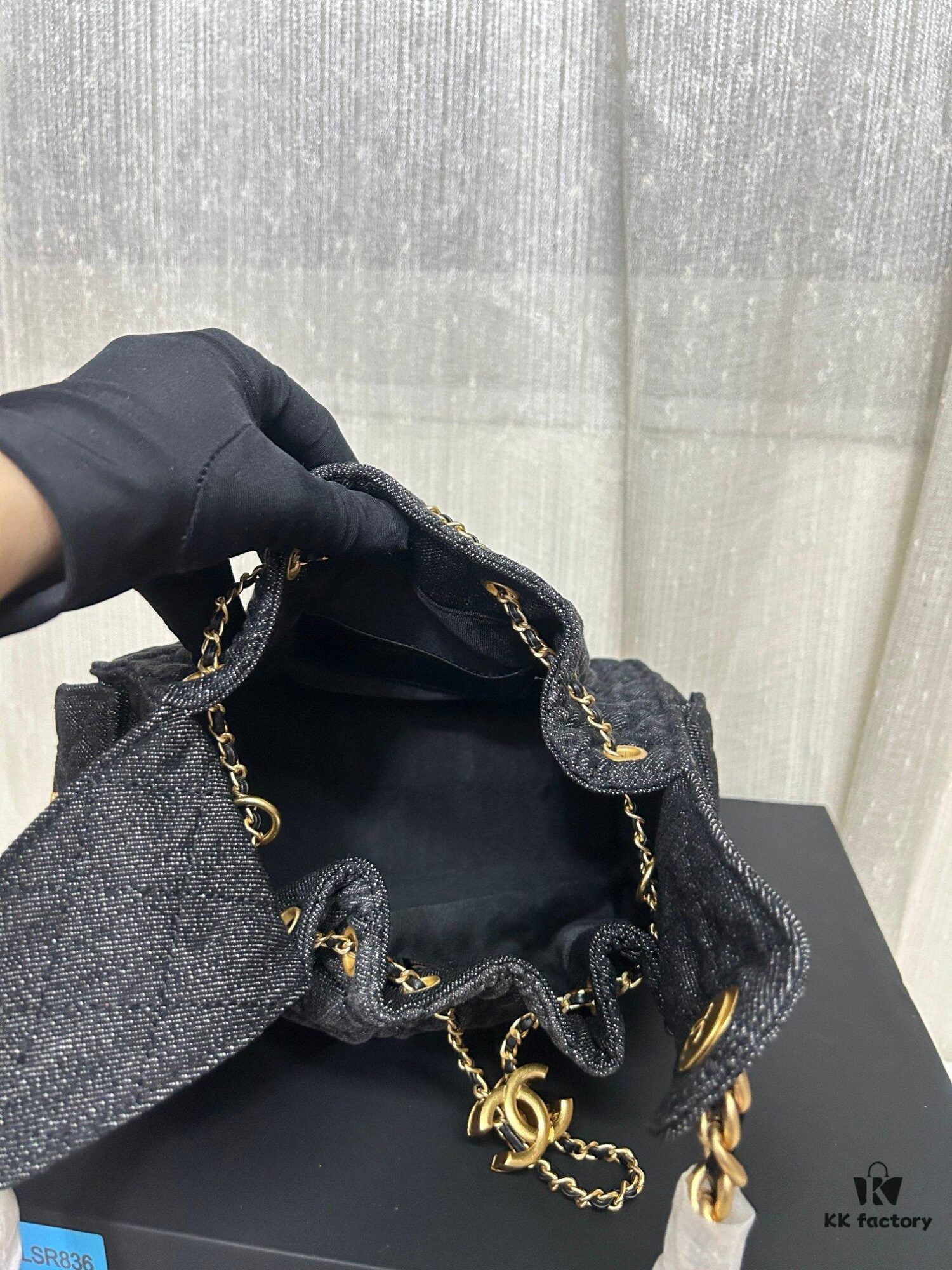 693047f3f09edb6de4c4e010 Chanel Washed Denim 25C Hobo Bag with Quilted Ball Texture, Vintage Coin Button Drawstring Bucket Bag in Retro Black and Gold with Diamond Stitching, Classic Chain Design