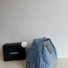 693047f6f09edb6de4c4e012 Chanel Washed Denim 25C Hobo Bag with Quilted Ball Texture, Vintage Coin Buckle Drawstring Bucket Bag in Retro Black and Gold with Diamond Stitching and Classic Chain Design